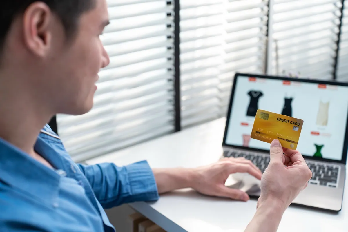 A shopper using a bank card to pay for an online purchase