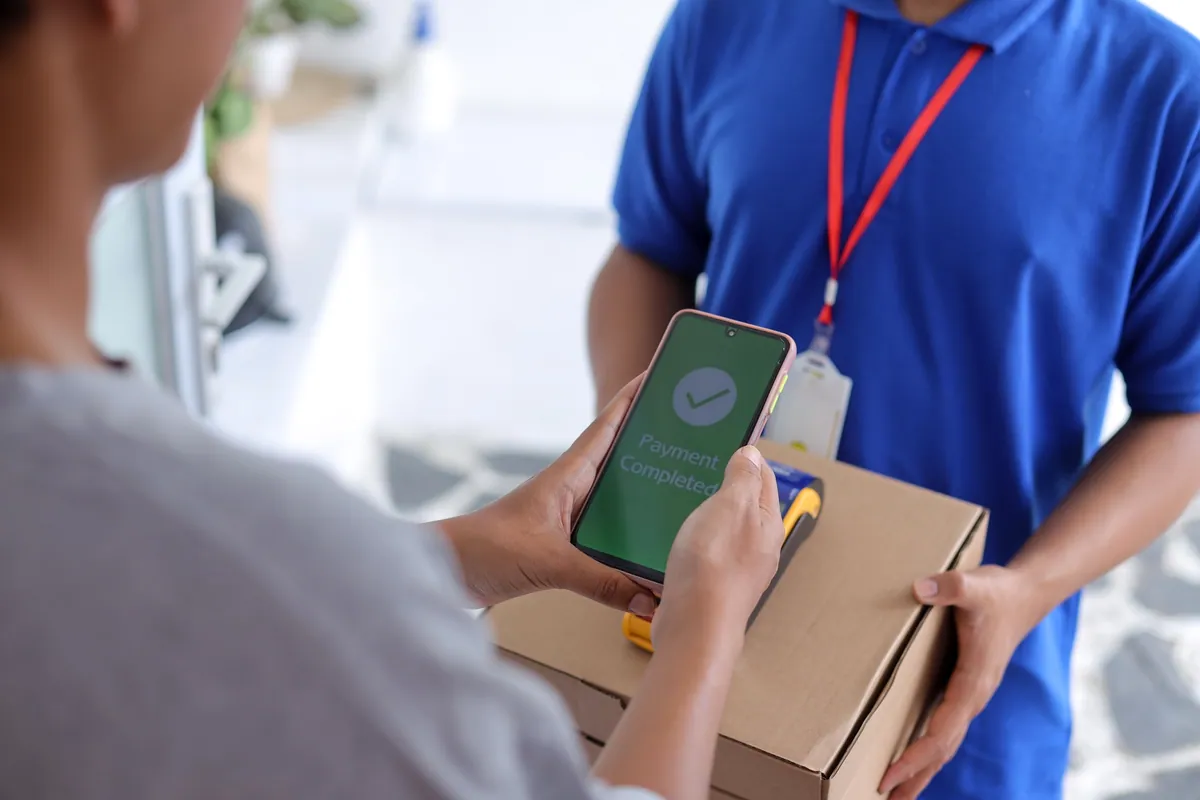 A customer confirming a parcel delivery on a phone